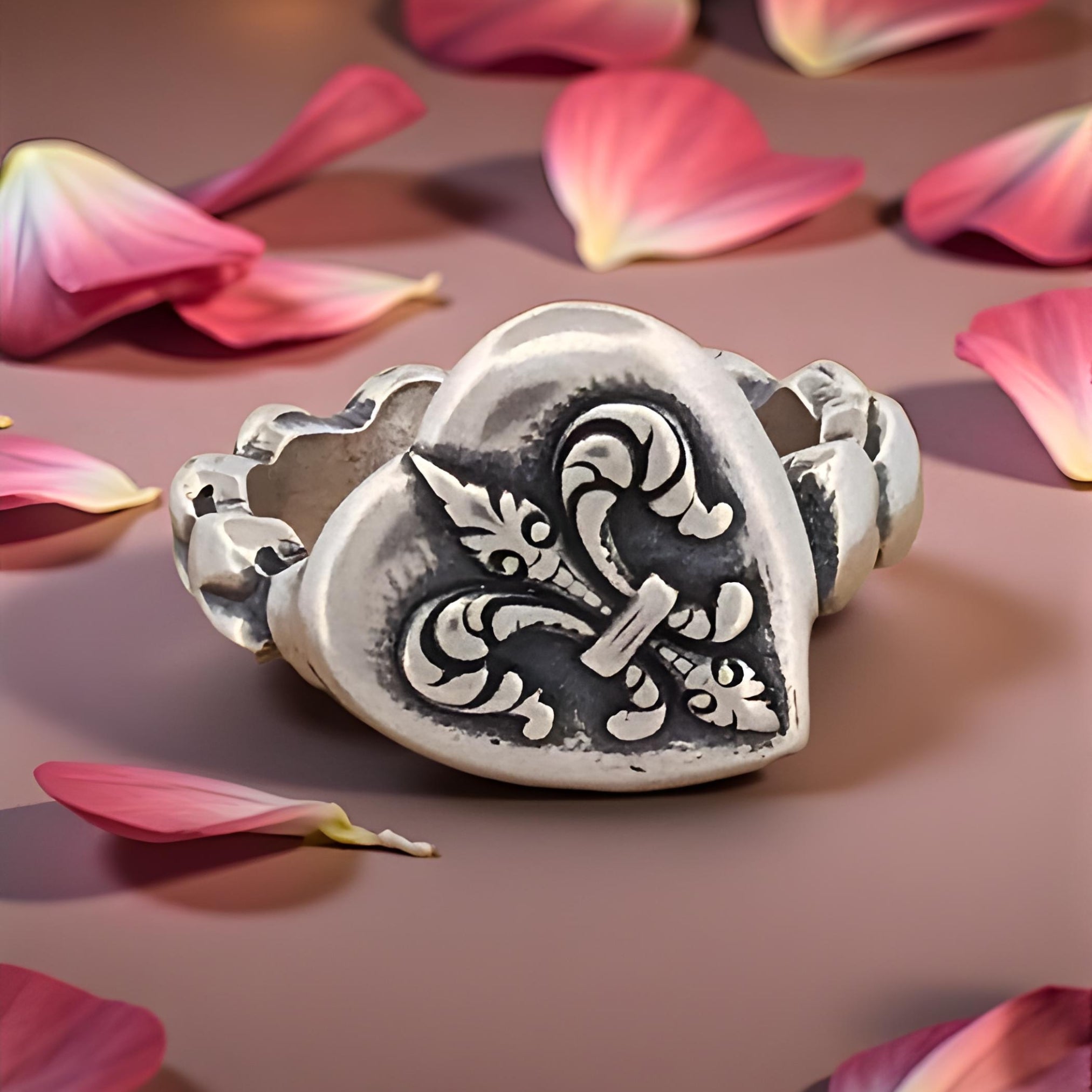 Silver bracelet with intricate design on a pink floral background